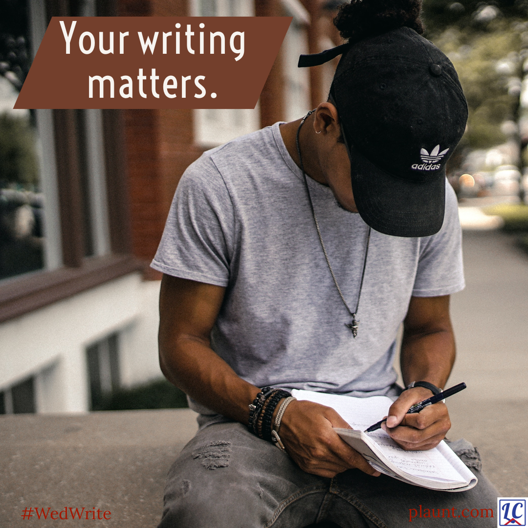 A young man sitting outside on a concrete wall writing in a notebook. A baseball cap hides his face from view as he looks down at his notes.