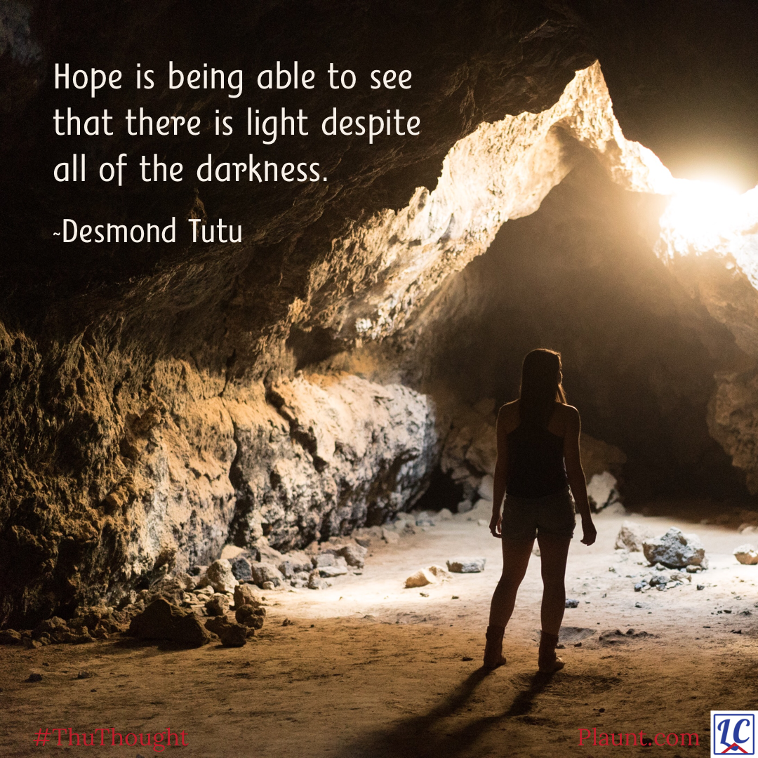 The silhouette of a woman in a cave looking up at sunlight streaming through a gap. Caption: Hope is being able to see that there is light despite all of the darkness. ~Desmond Tutu