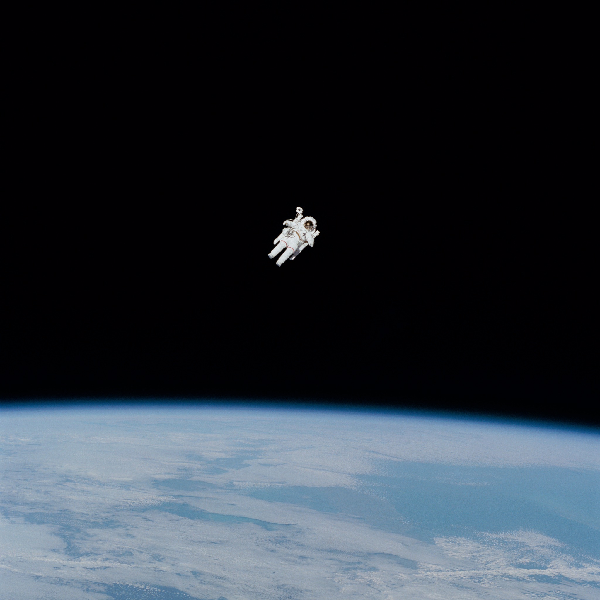 An astronaut floats in the vast darkness of space.